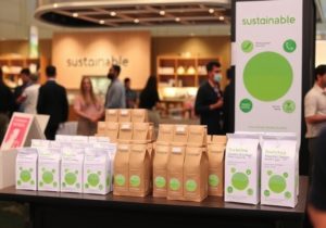 Sustainability-focused brand activation event with eco-friendly products, green decor, and audience participation in environmental awareness activities.